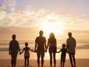 Why do we want family? A family with a kids standing at beach