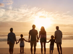 Why do we want family? A family with a kids standing at beach
