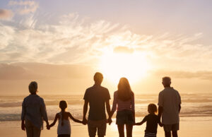 Why do we want family? A family with a kids standing at beach
