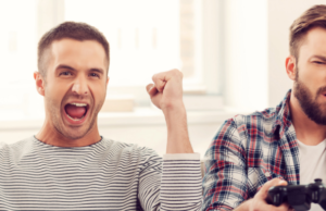 Main Advantages of Gaming: two person sitting on sofa and holding video game remote