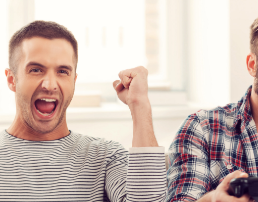 Main Advantages of Gaming: two person sitting on sofa and holding video game remote