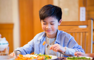 Why people give lots of importance to health? A boy eating aa food at dinning table