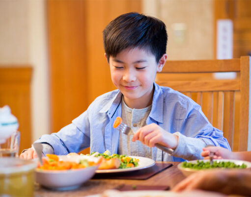 Why people give lots of importance to health? A boy eating aa food at dinning table