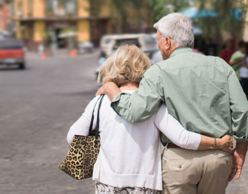 How a family and relationship take part in a person’s success? A old couple holding each other and walking on road