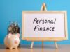 What is personal finance? piggybank and full bottle of coins and board