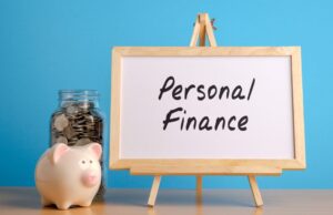What is personal finance? piggybank and full bottle of coins and board