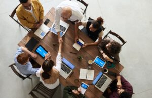 How to succeed in business? A group of people sitting at table and working in laptops
