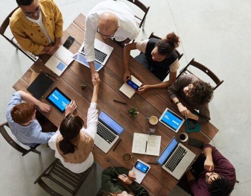 How to succeed in business? A group of people sitting at table and working in laptops
